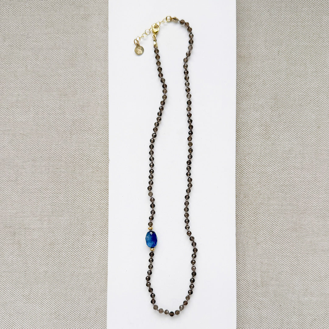 Smokey quartz knotted gemstone necklace on a white background