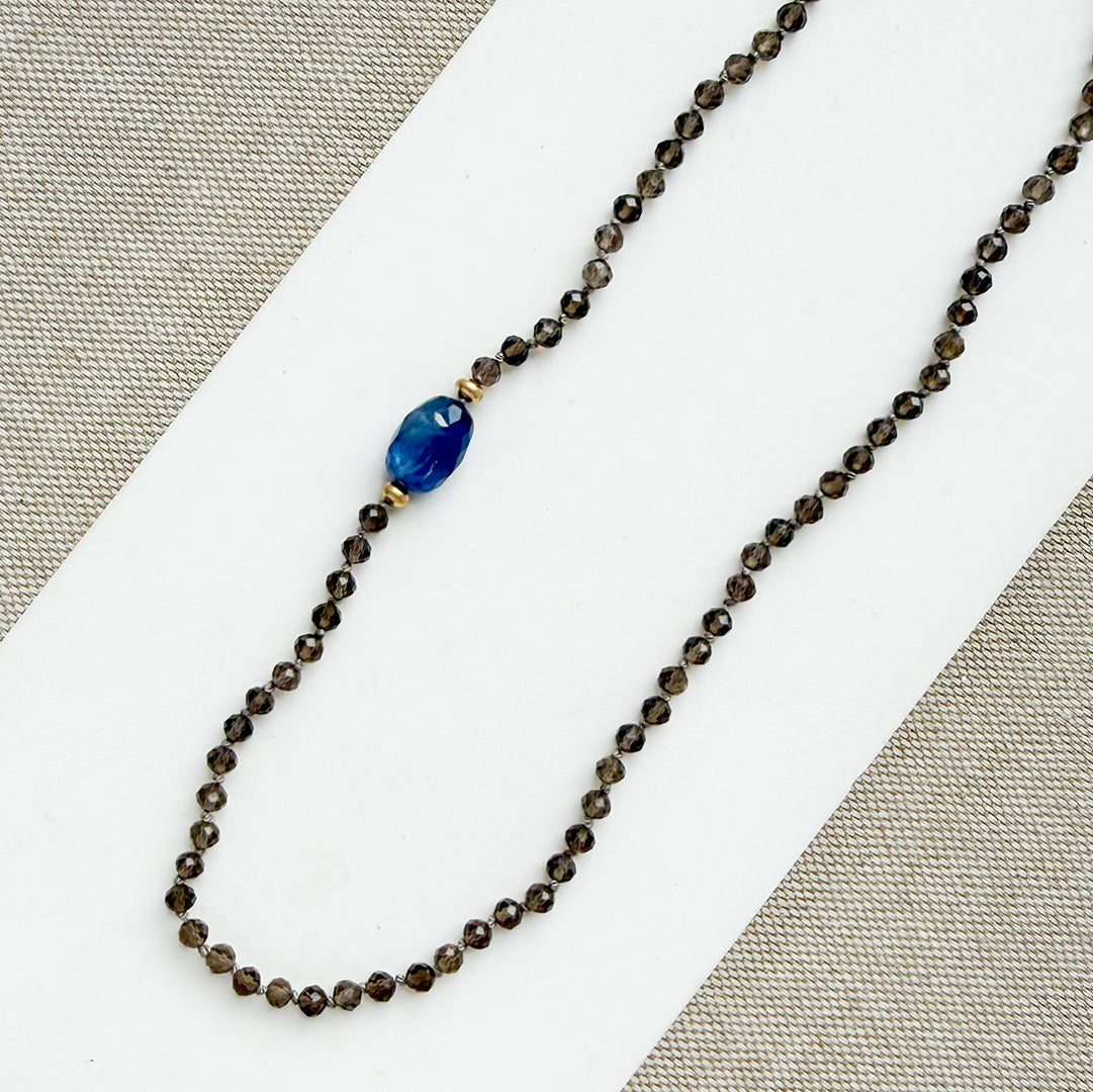 Smokey quartz knotted gemstone necklace on a white background
