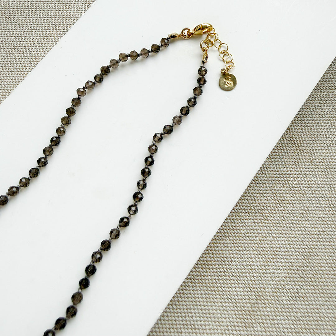 Smokey quartz knotted gemstone necklace on a white background