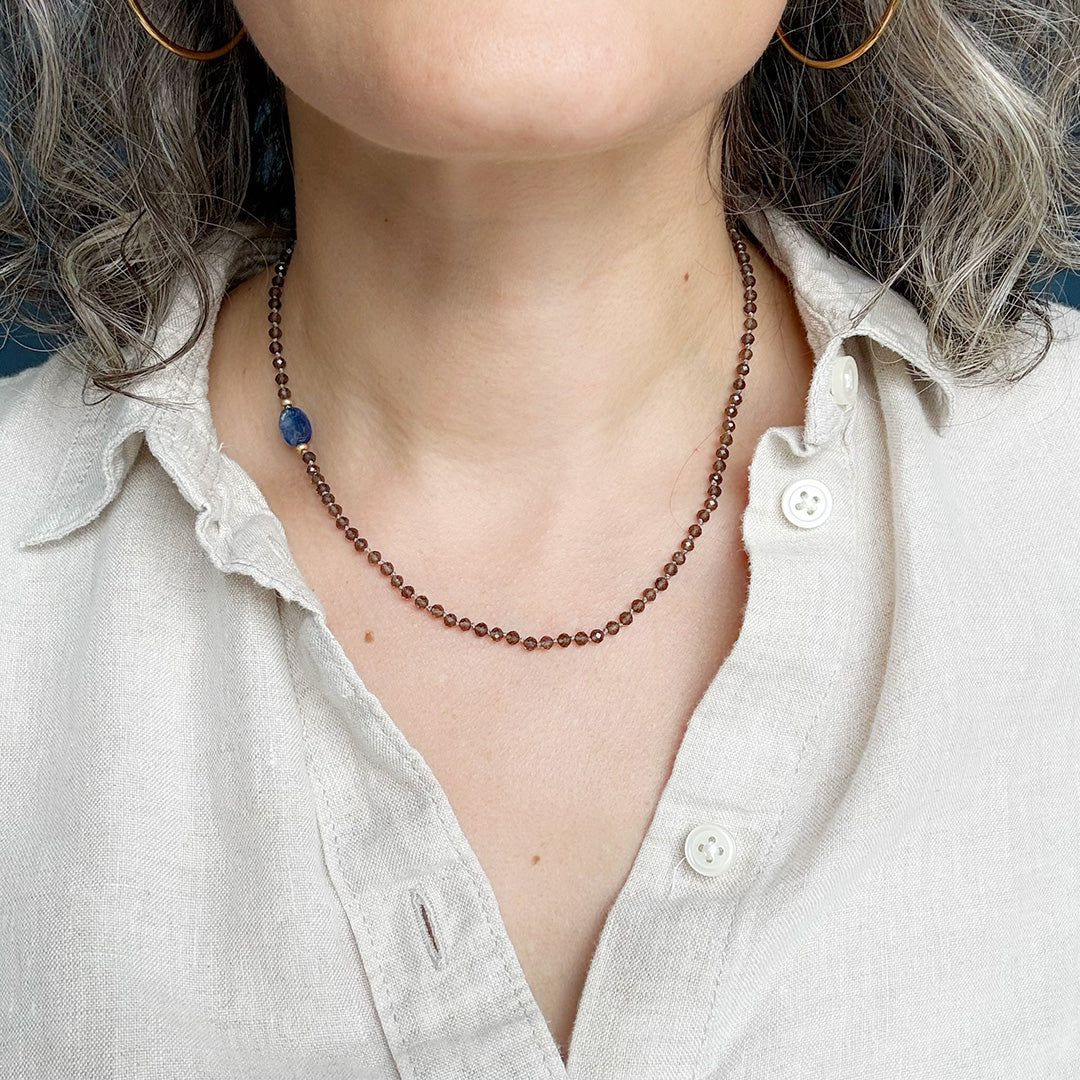 Person wearing smokey quartz knotted gemstone necklace 