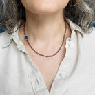 Person wearing smokey quartz knotted gemstone necklace 