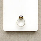 Oval berry spinel ring in a mixed metal setting
