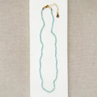 Bright blue apatite gemstone knotted necklace on a white background