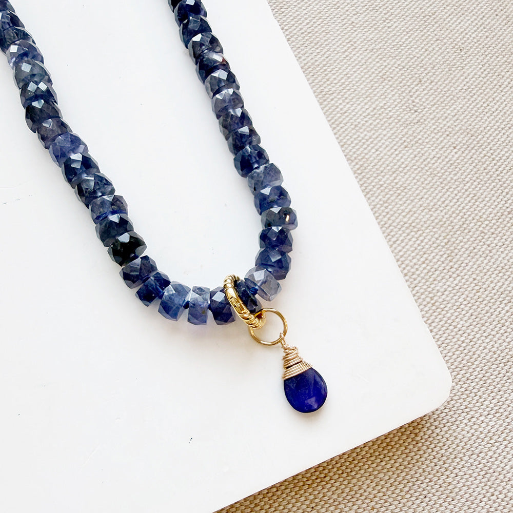 Teardrop shaped sapphire gemstone charm on  knotted gemstone necklace