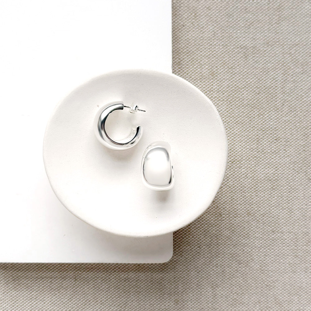 Chunky silver hoops in a white dish