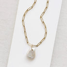 Keshi pearl charm with large gold ring on a gold paperclip chain