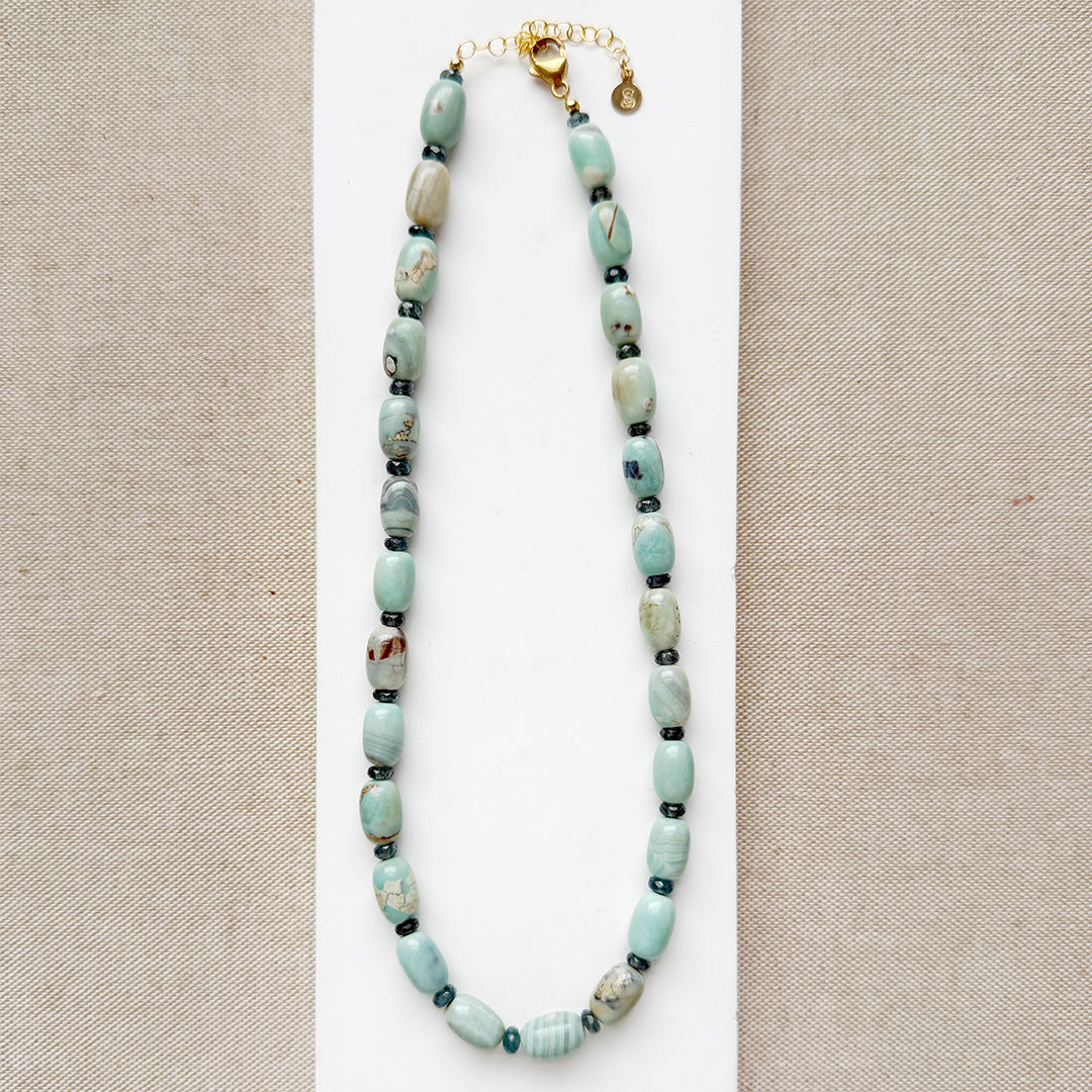 Necklace with teal agate beads on a beige background
