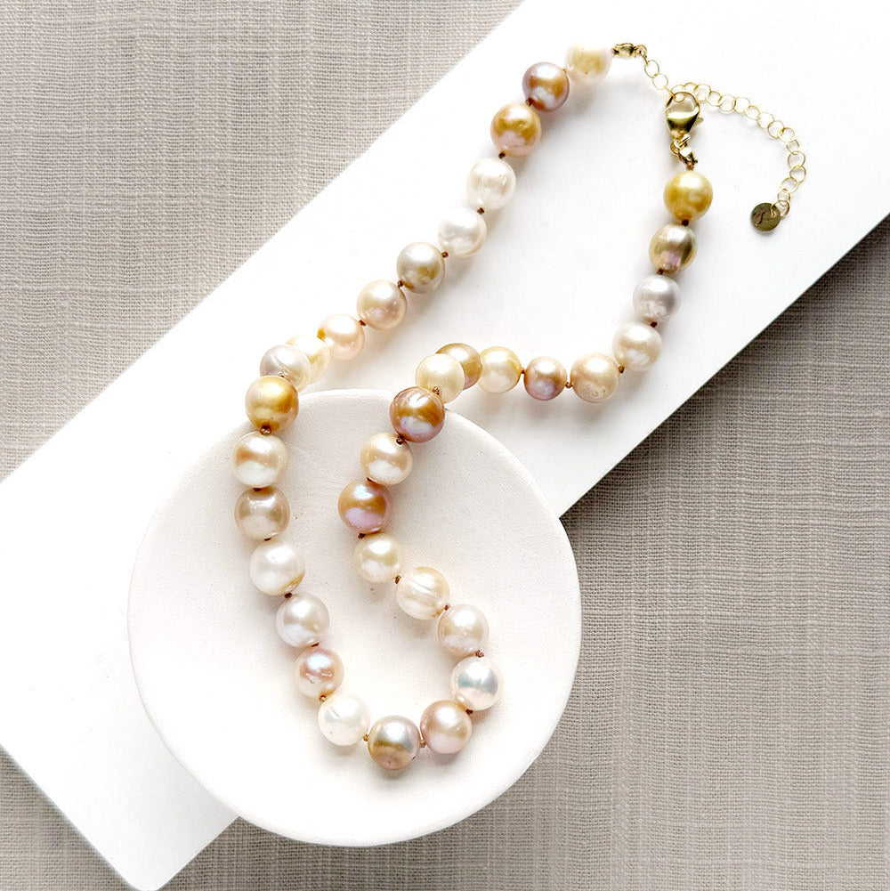 Champagne pearl knotted necklace in a white dish