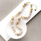 Champagne pearl knotted necklace in a white dish
