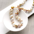 Champagne pearl knotted necklace in a white dish