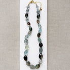 Copper aquamarine necklace on a white plate 