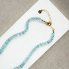 Aquamarine knotted necklace on a white card