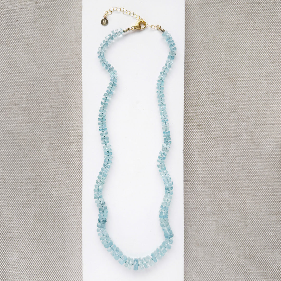 Aquamarine knotted necklace on a white card