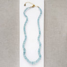 Aquamarine knotted necklace on a white card