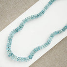 Aquamarine knotted necklace on a white card