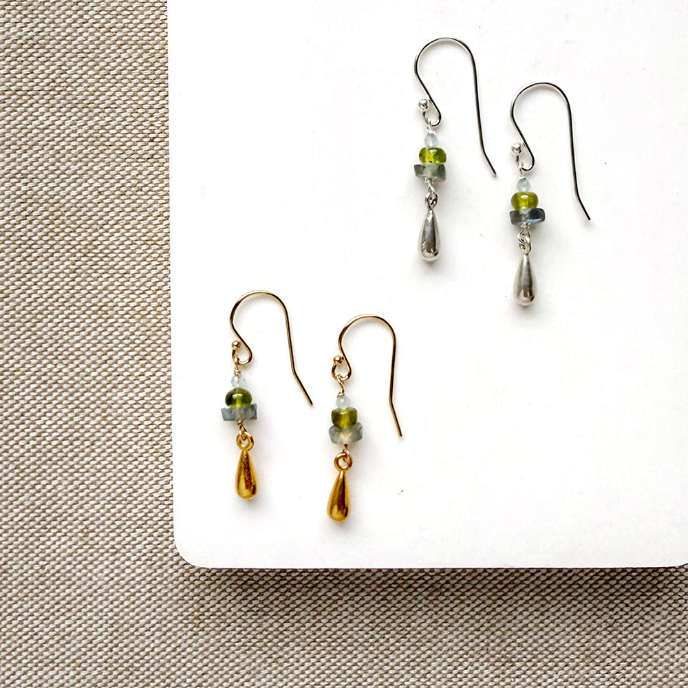 Gemstone and metal accent earrings in gold and silver on a white background
