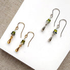 Gemstone and metal accent earrings in gold and silver on a white background