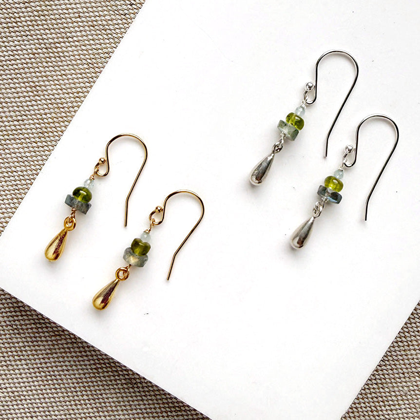 Gemstone and metal accent earrings in gold and silver on a white background