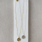 Gold and silver necklaces with round elephant pendants