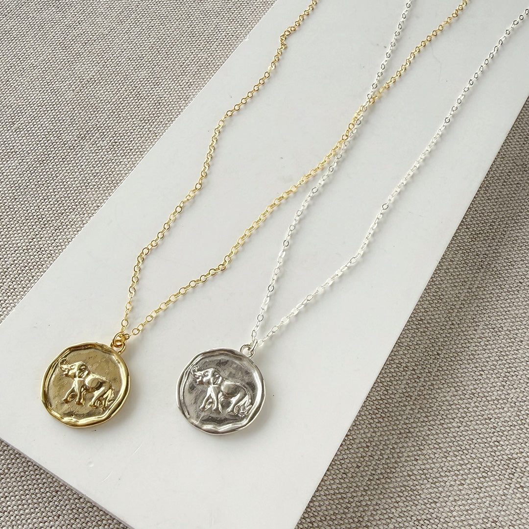 Gold and silver necklaces with round elephant pendants