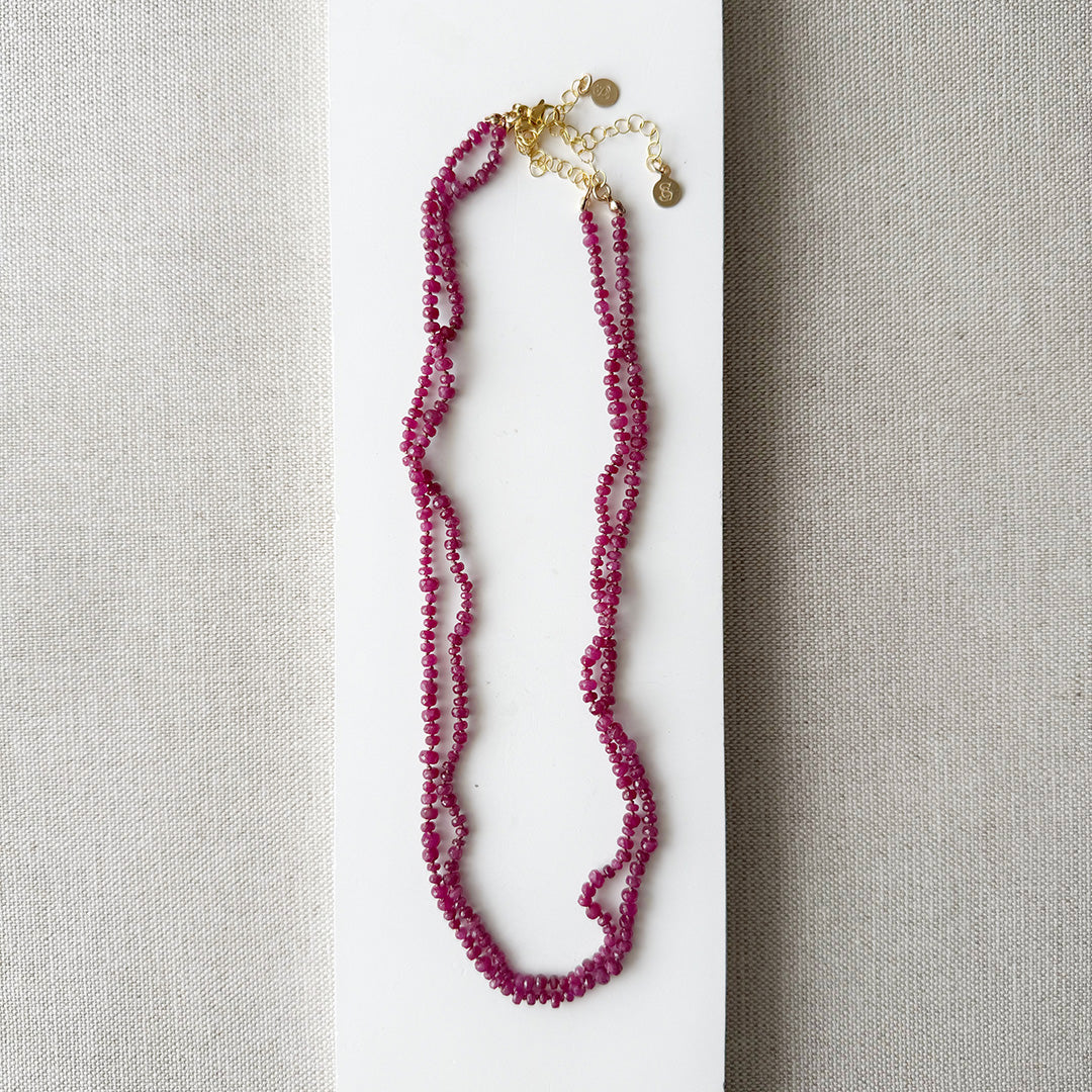 Small ruby gems knotted necklace on a light gray background