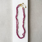 Small ruby gems knotted necklace on a light gray background