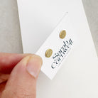 Hand holding a card with 'Sarah Coventry' branding on a neutral background