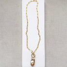 Gold necklace with large blush colored baroque pearl