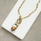 Gold necklace with large blush colored baroque pearl