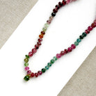 Necklace with smooth Watermelon Tourmaline in shades of pink, red, green, blue, and orange, featuring a small green tourmaline charm