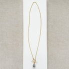 Gold necklace with toggle and moonstone drop