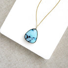 Golden Hills turquoise pendant necklace in solid gold on a white background 