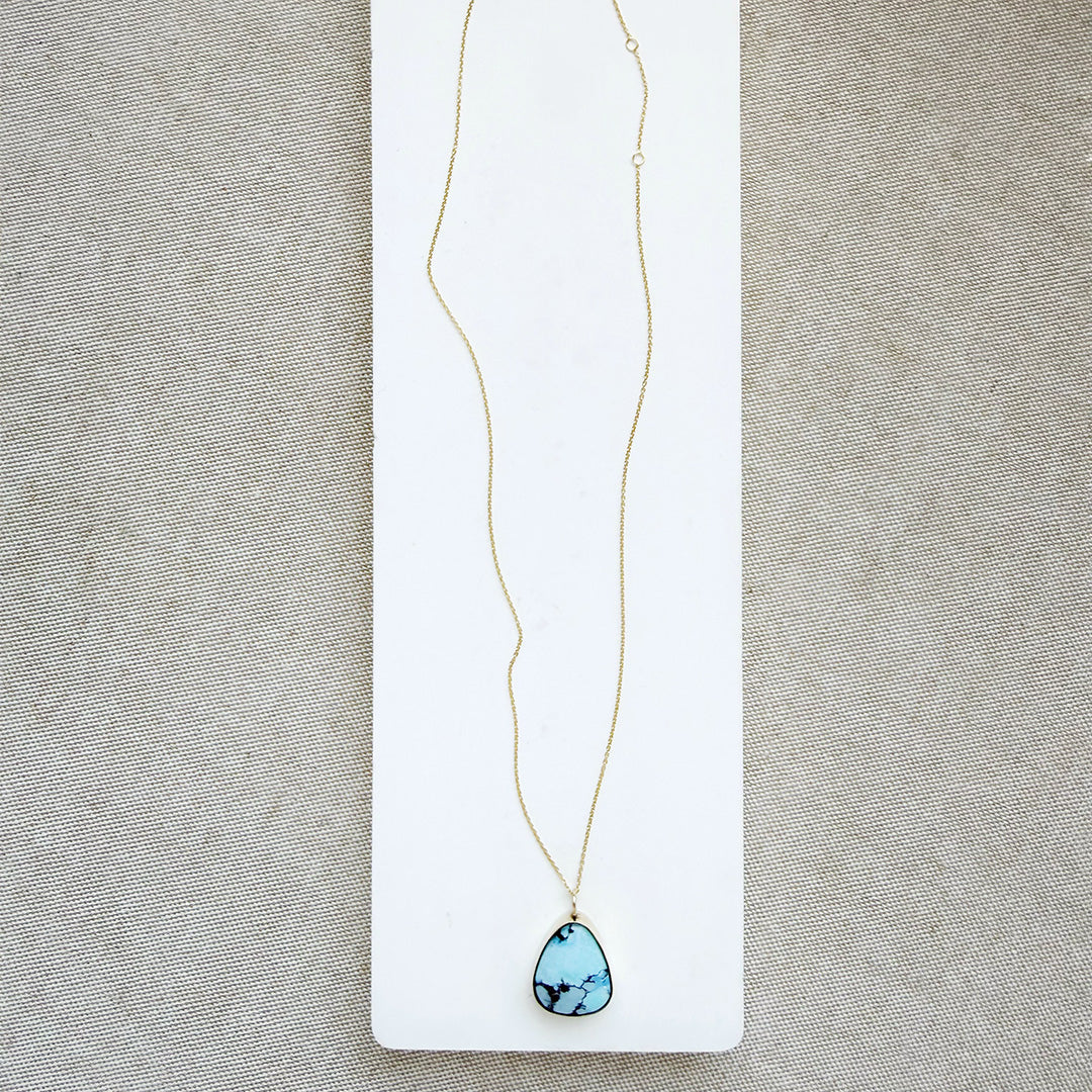Golden Hills turquoise pendant necklace in solid gold on a white background 