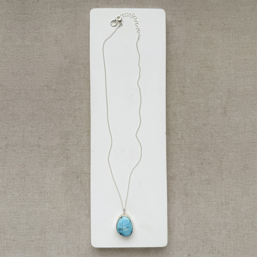 Golden Hills turquoise pendant necklace in sterling silver  on a white card.