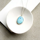 Golden Hills Turquoise pendant necklace in a white dish.
