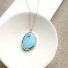 Golden Hills Turquoise pendant necklace in a white dish