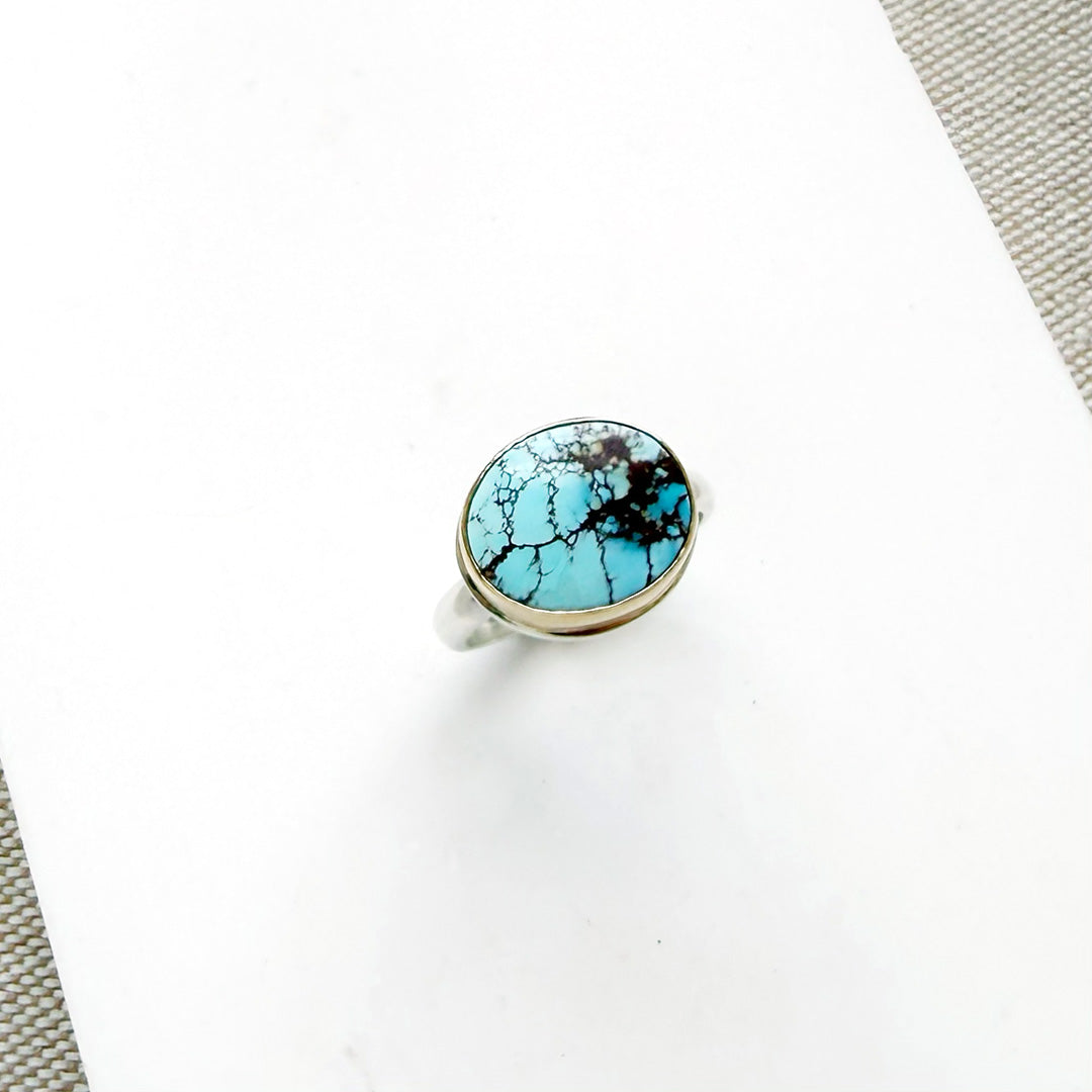 One of a kind Golden Hills turquoise mixed metal ring on a white background
