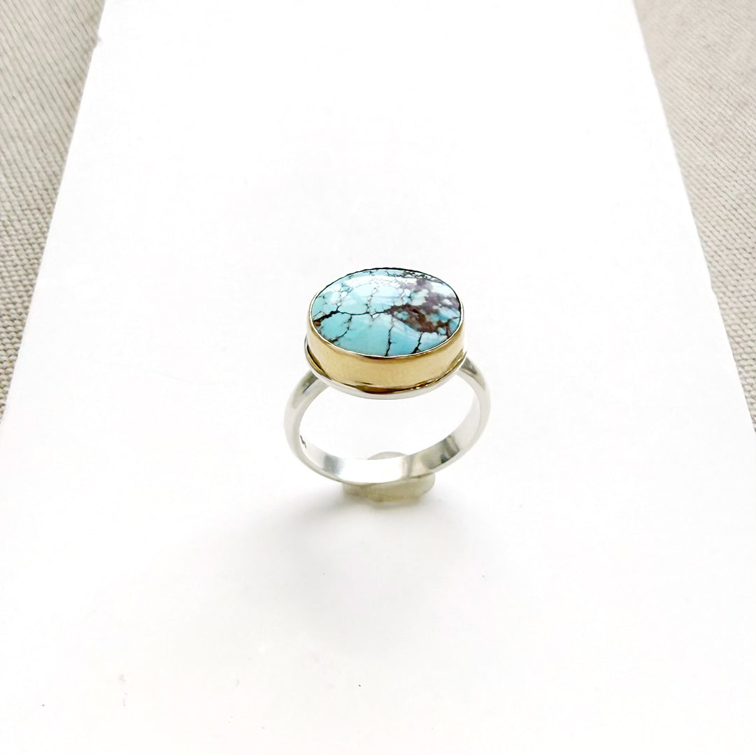 One of a kind Golden Hills turquoise mixed metal ring on a white background