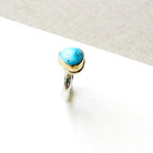One of a kind Golden Hills turquoise mixed metal ring on a white background