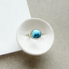 One of a kind Golden Hills Turquoise silver ring in a white dish