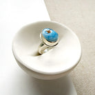 One of a kind Golden Hills Turquoise silver ring in a white dish