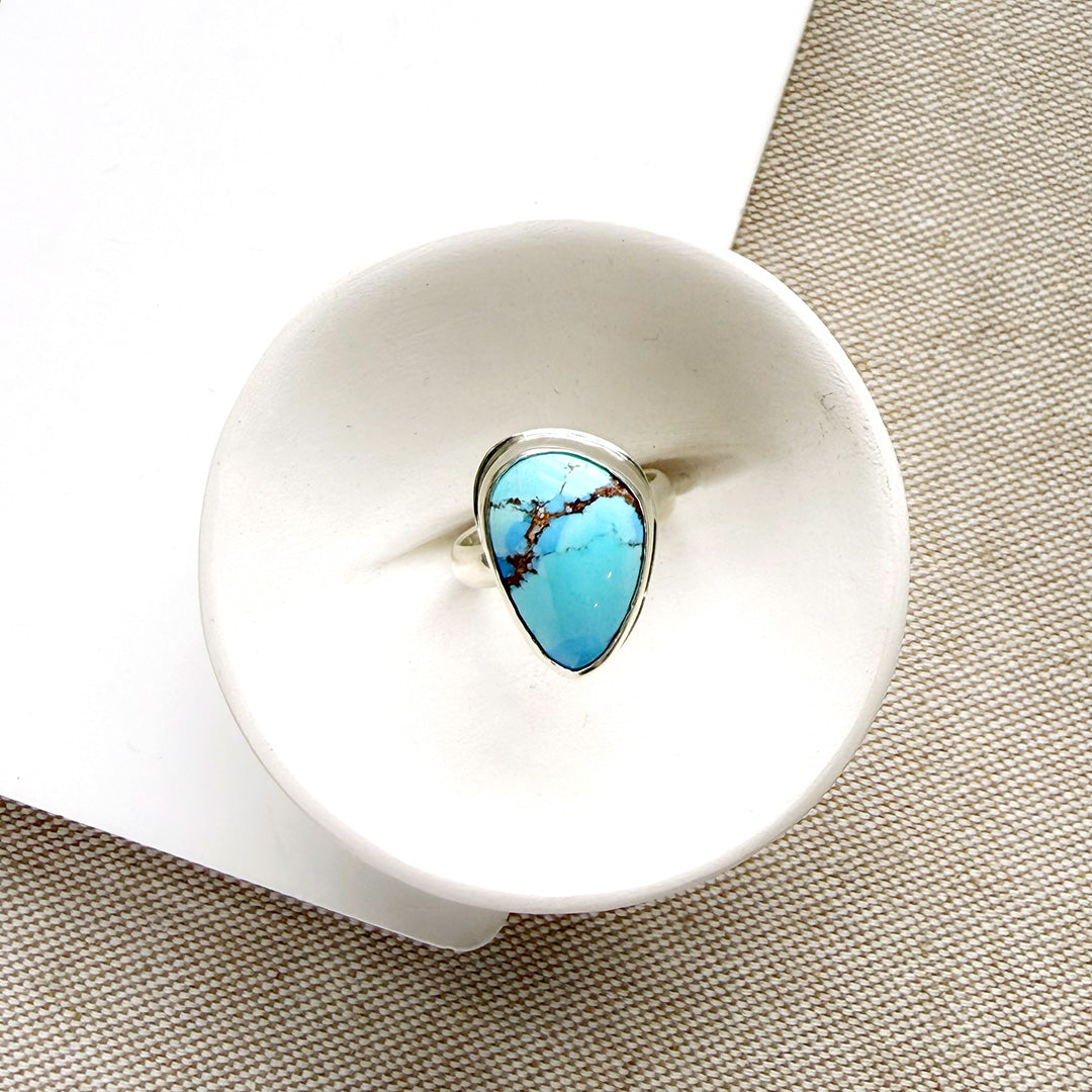 One of a kind Golden Hills Turquoise silver ring in a white dish