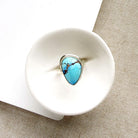 One of a kind Golden Hills Turquoise silver ring in a white dish
