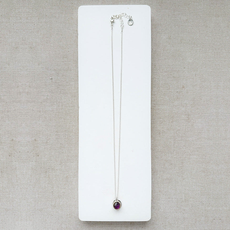 Silver gemstone pendant with carved scarab details