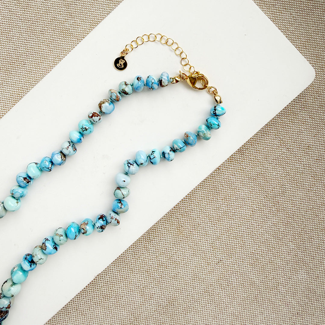 Golden Hills Turquoise knotted necklace on a white plate