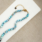 Golden Hills Turquoise knotted necklace on a white plate