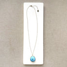 Golden Hills Pendant set in sterling silver on a white dish