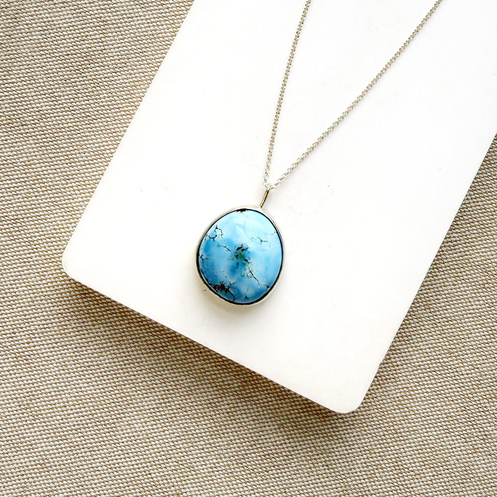 Golden Hills Pendant set in sterling silver on a white dish