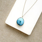 Golden Hills Pendant set in sterling silver on a white dish