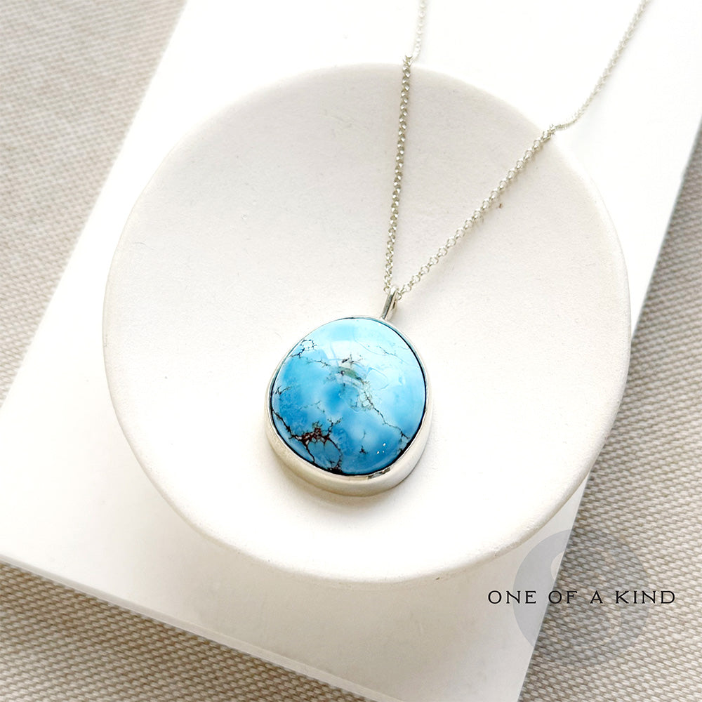 Golden Hills Pendant set in sterling silver in a white dish